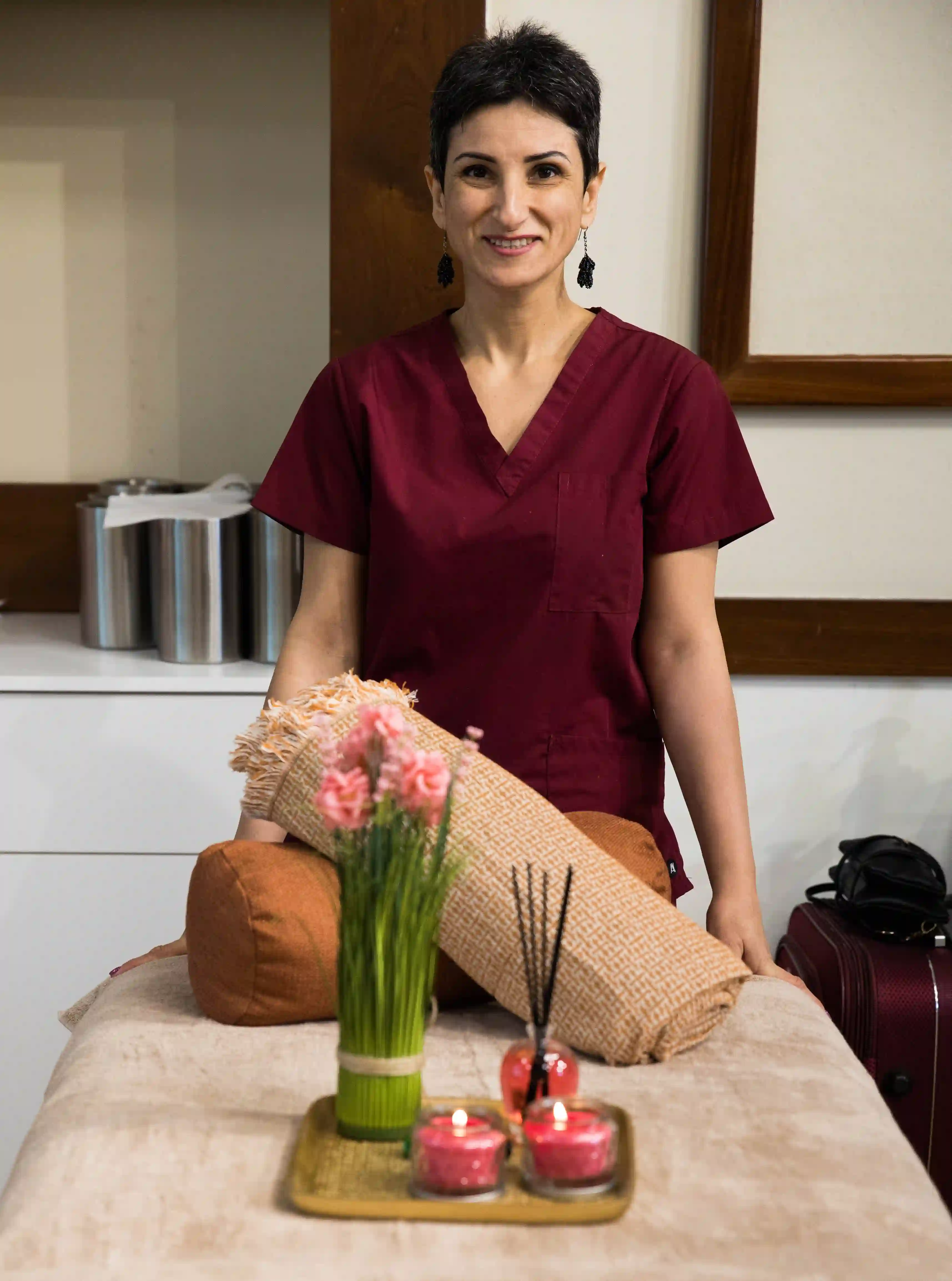 Armine Soghomonyan, professional massage therapist in Limassol, smiling in uniform
